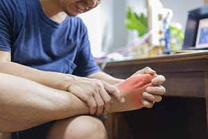 Man having Arthritis pain on his foot 